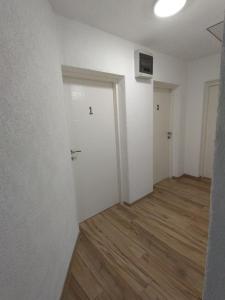 an empty room with white walls and wood floors at Nice view-Plitvice in Korenica