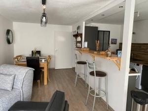 a living room and kitchen with a couch and a table at Cool Montagne in Briançon