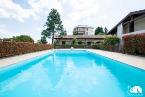 a swimming pool in the backyard of a house at The Three Moons Apartment in Peschiera del Garda