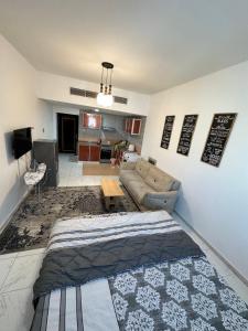 a living room with a bed and a couch at Apartment in Ajman,Studio flat in Ajman 