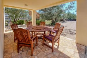 a wooden table and chairs on a patio at Kuća za odmor in Brzac