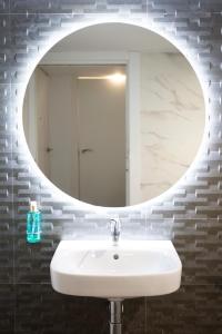 a bathroom with a white sink and a mirror at Presidente in Granada