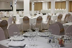 a banquet hall with white tables and chairs at Hotel Metropol – Metropol Lake Resort in Ohrid