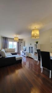 a large living room with a couch and a tv at TERRASOL AZUCARERA ATICO LUJO in Torre del Mar