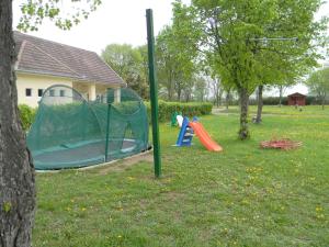 a playground with a tent and a slide in a park at Camping Eldorado in Gilău