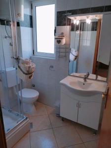 a bathroom with a sink and a toilet and a shower at Apartments Dalmacija in Podstrana +28 photos