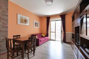 ein Wohnzimmer mit einem rosa Sofa und einem Tisch in der Unterkunft Mila Apartments Brizi in Mailand