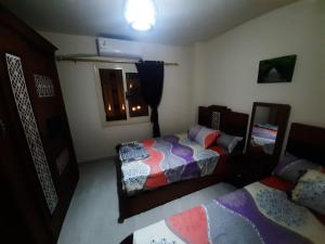 a bedroom with two beds and a window at قريه لاسرينا العين السخنة in Ain Sokhna
