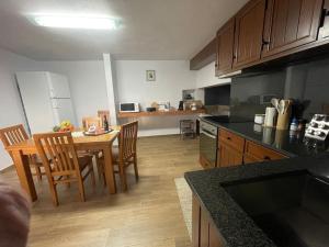 a kitchen with a table and chairs in a kitchen at Casa Rustica da Maloeira in Malseira