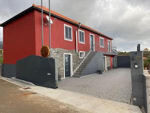 a red building with a staircase next to it at Casa Rustica da Maloeira in Malseira