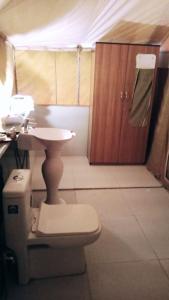 łazienka z toaletą i umywalką w namiocie w obiekcie Jungle Journey- A Lake Resort w mieście Kumbhalgarh