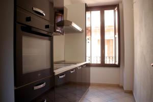 a kitchen with a sink and a window at Sardinian Gallery Corso in Bosa