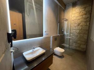 a bathroom with a sink and a toilet at Warszawski Alaçatı in Alaçatı