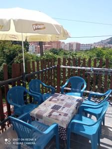 a table and chairs with an umbrella on a patio at apartman Dragic in Budva