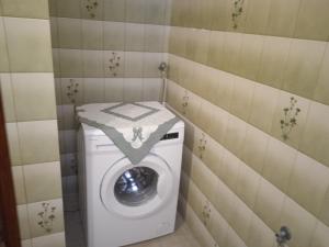 a washer and dryer in a corner of a bathroom at Aria in Batsi