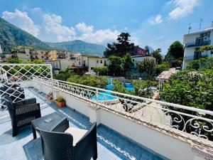 a balcony with chairs and a view of a city at YourHome - Villa Sorrento in Meta