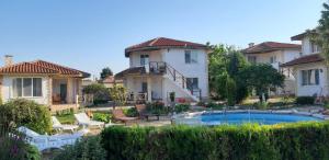 a house with a swimming pool in front of it at Къща за гости Света Марина in Krapets