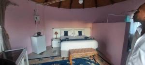 a bedroom with a white bed in a pink wall at Mmathaba Guest House in Mmadinare +74 photos