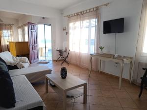 a living room with a couch and a table at Sea view Cycladic house in Tinos