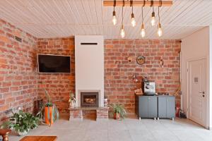a living room with a brick wall and a fireplace at Апарт- готель SunRay in Skhidnitsa