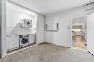 a laundry room with a washer and dryer in it at Bright & Easy - Address is 7 Cobb & C Way Pet Friendly Inside in Robe