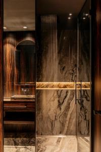 a bathroom with a shower with a glass door at Hotel Bagués, a Small Luxury Hotel of the World in Barcelona