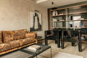 a living room with a couch and two chairs at Hotel Bagués, a Small Luxury Hotel of the World in Barcelona