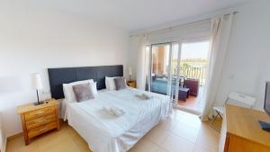 a bedroom with a large white bed and a balcony at Casa Espliego A-Murcia Holiday Rentals Property in Torre-Pacheco +11 photos