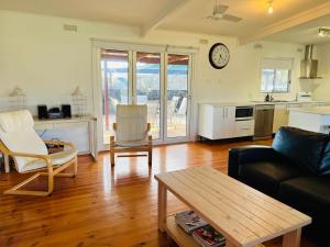 a living room with a couch and a table at Teddy's Shack - Pet Friendly in Robe