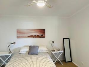 a bedroom with a bed and two night stands at Teddy's Shack - Pet Friendly in Robe