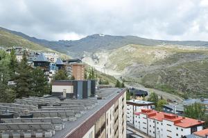 a view of a city with buildings and mountains at Holidays, Duplex para 4, Gorbea in Sierra Nevada
