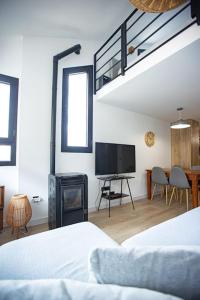 a bedroom with a bed and a flat screen tv at Holidays, Duplex para 4, Gorbea in Sierra Nevada