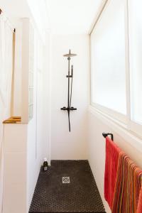 a cross on the wall of a bathroom with a towel at Cozy room on the beach in La Ciotat
