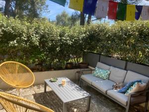 a cat sleeping on a couch on a patio at Cozy room on the beach in La Ciotat