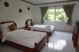 Voodi või voodid majutusasutuse Chaweng Tara Hotel toas
