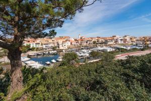 a view of a marina with boats in a harbor at La Lampara - Casa Panoramica 4 Km dalla Pelosa in Stintino