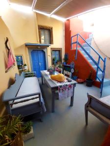 a living room with a table and a blue ladder at Emmantina in Mesaria