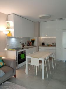 eine Küche mit einem Tisch und Stühlen im Zimmer in der Unterkunft Złoty apartament Bokserska in Warschau