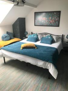 a bedroom with two beds with blue pillows at Villa Sylvania in Spa