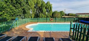 a swimming pool with a fence and chairs next to it at Dalias - Con Piscina, Parque Infantil, Juegos, 6 hab, 3 baños - VV-256-AS in Argüero
