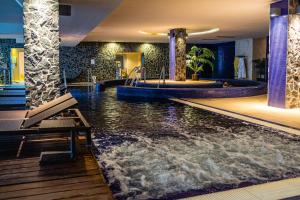 a pool in a hotel with a water slide at Lifestyle Hotel M&aacute;tra in M&aacute;trah&aacute;za