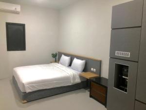Ένα ή περισσότερα κρεβάτια σε δωμάτιο στο Uresidence Bengkulu