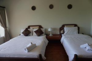 Voodi või voodid majutusasutuse Chaweng Tara Hotel toas