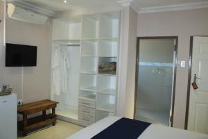a bedroom with a bed and a walk in closet at Mmathaba Guest House in Mmadinare