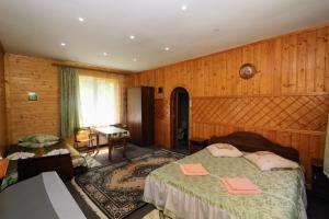 a bedroom with two beds and a table in it at Cottage "Gribochok" in Yaremche