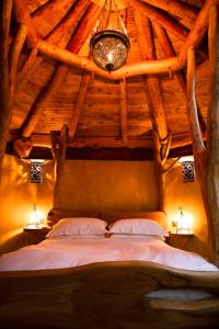 a bedroom with a bed in a wooden ceiling at Little Hollows Glamping in Little Malvern