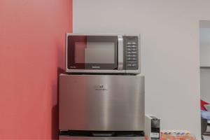 a microwave sitting on top of a refrigerator at "Casa Picasso" Elegant Studio in the Heart of Genova in Genova +77 photos
