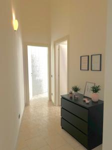 a living room with a dresser and a hallway at Ampio e Confortavole Appartamento a Voghera in Voghera