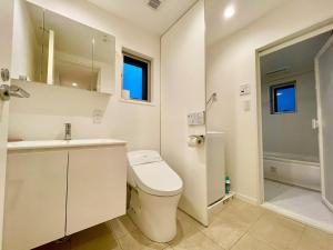 a bathroom with a toilet and a sink and a shower at SALON渋谷4B in Tokyo