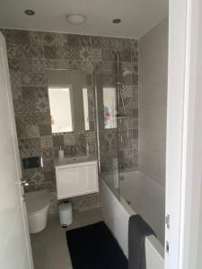 a bathroom with a tub and a sink and a shower at Modern 3 Bed Town House Marina Hull in Hull